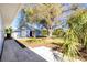 Charming backyard featuring a cute blue shed and a sprawling shade tree at 434 W Grace St, Punta Gorda, FL 33950