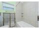 Unfinished bathroom showcasing a shower and window with natural light at 434 W Grace St, Punta Gorda, FL 33950
