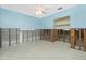 A bedroom undergoing renovation with an open closet space, exposed block, framing, and a ceiling fan at 434 W Grace St, Punta Gorda, FL 33950