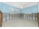 Partially renovated bedroom featuring exposed framing, block wall, a window, and a ceiling fan at 434 W Grace St, Punta Gorda, FL 33950