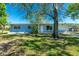 Cozy single-story blue home with a well-maintained front yard, enhanced by mature trees and inviting landscaping at 434 W Grace St, Punta Gorda, FL 33950