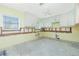 Partially renovated kitchen with white cabinets, exposed framing, and a ceiling fan at 434 W Grace St, Punta Gorda, FL 33950