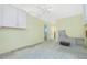 Under renovation kitchen with yellow walls, ceiling fan, exposed framing, and open access to the hall at 434 W Grace St, Punta Gorda, FL 33950