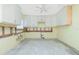 Partially renovated kitchen with white cabinets, exposed framing, and a ceiling fan at 434 W Grace St, Punta Gorda, FL 33950