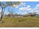 Large backyard with a well-maintained lawn and view of the home's exterior at 5211 Prime Ter, North Port, FL 34286