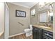 Stylish bathroom featuring a modern vanity with ample storage and a clean, well-maintained toilet at 5211 Prime Ter, North Port, FL 34286