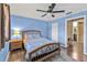 Comfortable bedroom featuring hardwood floors, modern light fixture, and ceiling fan at 5211 Prime Ter, North Port, FL 34286