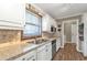 Spacious kitchen with stainless sink, matching appliances, and stylish backsplash at 5211 Prime Ter, North Port, FL 34286