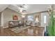 Comfortable living room featuring hardwood floors, stylish furnishings, and ample space for relaxation and entertainment at 5211 Prime Ter, North Port, FL 34286