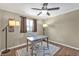 Bright office space with a ceiling fan, modern desk, and attractive flooring and neutral paint at 5211 Prime Ter, North Port, FL 34286