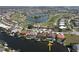 Waterfront property with a private dock, surrounded by a picturesque community with golf course in the background at 556 Monaco Dr, Punta Gorda, FL 33950