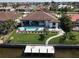 Aerial view of waterfront home with pool, fenced yard, and private dock at 556 Monaco Dr, Punta Gorda, FL 33950