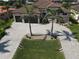 Gorgeous home featuring a paver driveway, two-car garage, lush lawn, and lovely landscaping with mature palm trees at 556 Monaco Dr, Punta Gorda, FL 33950