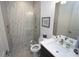 Modern bathroom with stand up shower featuring patterned tile, glass door, and stone tile floor at 556 Monaco Dr, Punta Gorda, FL 33950