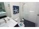 Bathroom featuring modern finishes, a glass-enclosed shower with blue rock floor, and a white vanity at 556 Monaco Dr, Punta Gorda, FL 33950