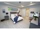 Cozy bedroom with a tray ceiling, neutral decor, and ensuite bathroom access at 556 Monaco Dr, Punta Gorda, FL 33950