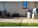 Exterior of home showing AC units and utilities area with rock covering at 556 Monaco Dr, Punta Gorda, FL 33950