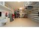 Spacious garage with ample storage, epoxy floor, shelving, and ceiling fan at 556 Monaco Dr, Punta Gorda, FL 33950