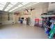 Spacious garage with storage racks, epoxy flooring, ceiling fans, and garage door with windows at 556 Monaco Dr, Punta Gorda, FL 33950