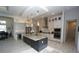 This open concept kitchen includes stainless appliances, custom cabinetry, a center island, and stylish lighting at 556 Monaco Dr, Punta Gorda, FL 33950