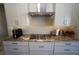 This close up shows a gas cooktop, stainless steel appliances, and a designer backsplash at 556 Monaco Dr, Punta Gorda, FL 33950