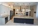 Gourmet kitchen features stainless steel appliances, custom cabinetry, a striking center island, and modern pendant lighting at 556 Monaco Dr, Punta Gorda, FL 33950
