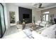 Bright living room featuring neutral tones, modern furnishings, ceiling fan, and a sleek, modern fireplace at 556 Monaco Dr, Punta Gorda, FL 33950