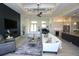 Open-concept living room featuring a coffered ceiling, fireplace, and modern decor at 556 Monaco Dr, Punta Gorda, FL 33950