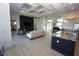 Expansive open-concept living area with modern décor, including a fireplace, piano, and chef's kitchen at 556 Monaco Dr, Punta Gorda, FL 33950