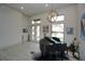 Elegant music room with high ceilings, a grand piano, and natural light streaming through the windows at 556 Monaco Dr, Punta Gorda, FL 33950