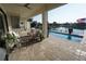 View of the covered outdoor patio with access to the pool and waterfront at 556 Monaco Dr, Punta Gorda, FL 33950