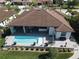 Aerial view of a backyard oasis with a sparkling pool and an extended patio area, perfect for outdoor living at 556 Monaco Dr, Punta Gorda, FL 33950