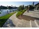 Landscaped walkway leading to the water, complemented by lush greenery and outdoor seating at 556 Monaco Dr, Punta Gorda, FL 33950