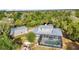 Aerial view of property with fenced pool area, separate garage, and lots of surrounding trees at 5601 Taylor Rd, Punta Gorda, FL 33950