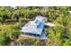 Aerial view of house with surrounding trees, screened-in pool, separate garage and wrap around porch at 5601 Taylor Rd, Punta Gorda, FL 33950