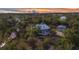 Sunset aerial showcasing a beautiful home, large lot, lush landscaping, and garage at 5601 Taylor Rd, Punta Gorda, FL 33950