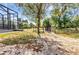 Spacious backyard features a fence, mature trees, and lush greenery, creating a private outdoor retreat at 5601 Taylor Rd, Punta Gorda, FL 33950