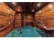 Spacious wood-paneled basement with blue floor, offering potential for a workshop or recreational area at 5601 Taylor Rd, Punta Gorda, FL 33950