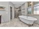 Bright bathroom with a freestanding tub, marble flooring, and a glass shower at 5601 Taylor Rd, Punta Gorda, FL 33950