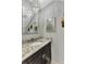 Powder room with granite vanity, modern sink and lighting fixture, and sloped ceiling at 5601 Taylor Rd, Punta Gorda, FL 33950