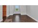 A sun-lit bedroom featuring wood floors and neutral walls at 5601 Taylor Rd, Punta Gorda, FL 33950