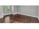 Clean, light-filled bedroom with wood floors and a bright window at 5601 Taylor Rd, Punta Gorda, FL 33950