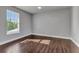 Bright bedroom with a ceiling fan, hardwood floors, fresh paint and large window at 5601 Taylor Rd, Punta Gorda, FL 33950