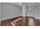 Bedroom featuring hardwood floors, white trim, and a large window for plenty of natural light at 5601 Taylor Rd, Punta Gorda, FL 33950