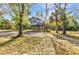 Charming elevated playhouse set among mature trees, offering a whimsical outdoor space for to explore at 5601 Taylor Rd, Punta Gorda, FL 33950
