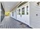 Up-close view of the front porch with double-door entry, wood flooring, and homey welcome mat at 5601 Taylor Rd, Punta Gorda, FL 33950