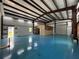 Open, detached garage space with a blue epoxy floor, a roll-up door, and windows at 5601 Taylor Rd, Punta Gorda, FL 33950