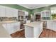 Modern kitchen with stainless steel appliances, island, and a view to the living room at 5601 Taylor Rd, Punta Gorda, FL 33950