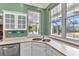 Kitchen with stainless steel dishwasher, and double sink, with three windows for plenty of light at 5601 Taylor Rd, Punta Gorda, FL 33950