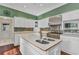 Spacious island kitchen with stainless steel oven, and mosaic tile backsplash at 5601 Taylor Rd, Punta Gorda, FL 33950